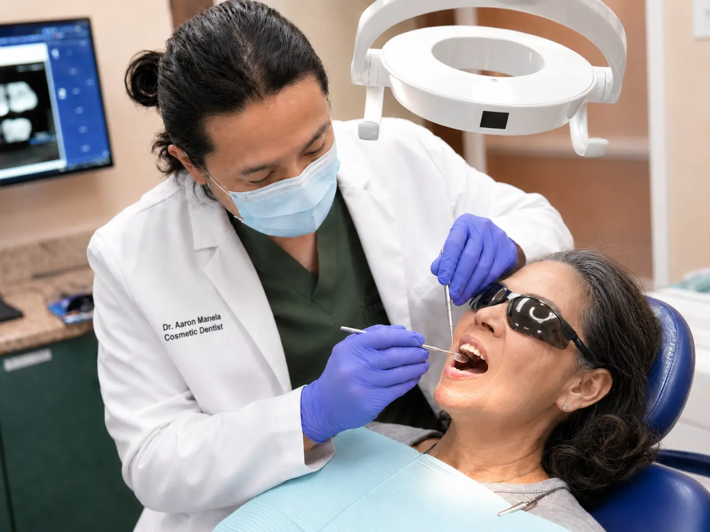 Dr. Manela examining a patient at iCare Orthodontics and Dentistry in Norcross, GA