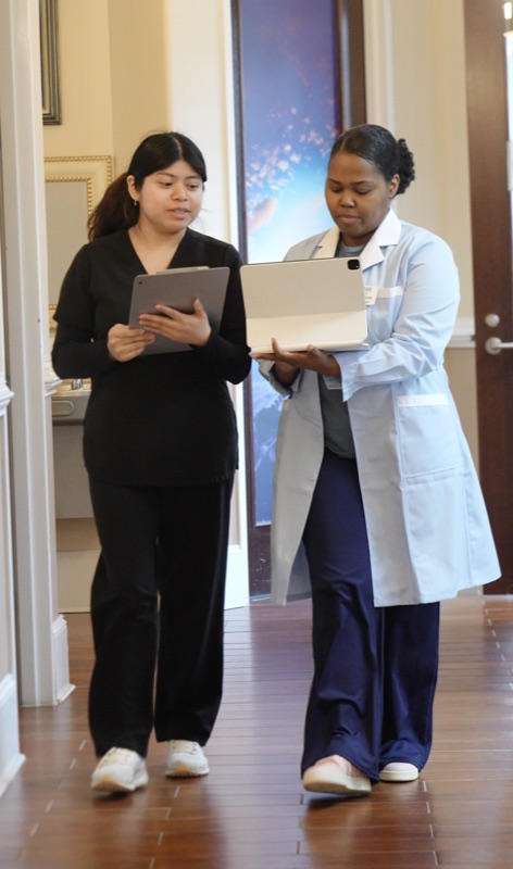 iCare team members reviewing patient records on iPads at the Norcross, GA office