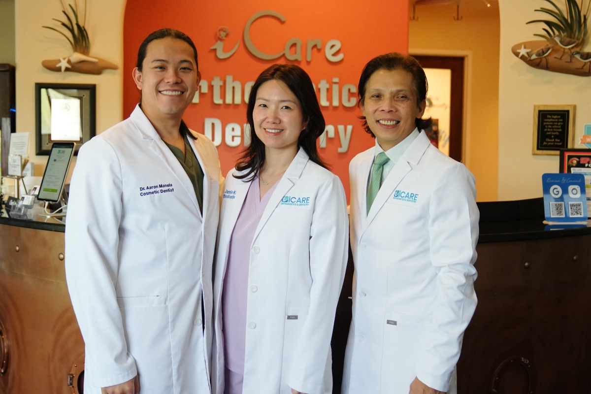From left, Dr. Aaron Manela, Dr. Jamie Kim and Dr. Vinh Huynh at the front desk of iCare Orthodontics and Dentistry, a doctor-led private orthodontic and dental practice in Norcross, GA
